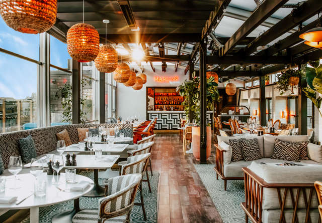 Restaurant and bar at Virgin Hotels London-Shoreditch with contemporary décor, plush seating, and a sleek design.