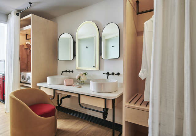 Suite vanity with luxury amenities and his and her sinks at Virgin Hotels New York.