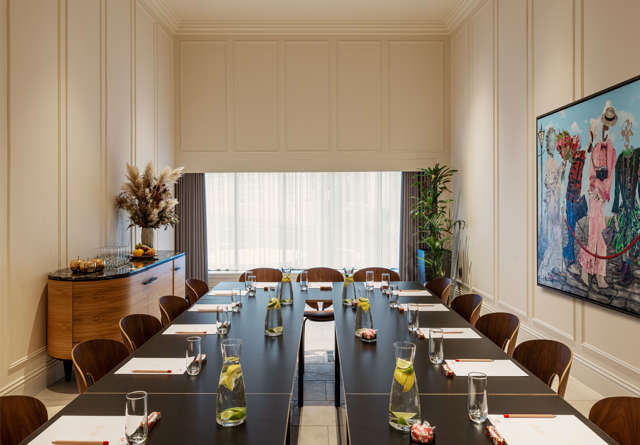Modern event space in Virgin Hotels Edinburgh with elegant decor, stylish furniture, and large windows.